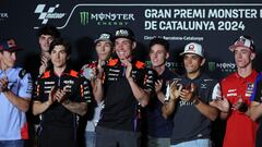 Aprilia Spanish rider Aleix Espargaro (C) applauds flanked by other riders, after announcing his retirement from MotoGP at the end of the 2024 season, during a press conference at the Catalunya racetrack in Montmelo, near Barcelona, on May 23, 2024, ahead of the Catalunya Moto GP Grand Prix. (Photo by LLUIS GENE / AFP)
