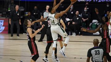 Milwaukee Bucks' Giannis Antetokounmpo (34) goes up for a shot in front of Miami Heat's Duncan Robinson (55) in the second half of an NBA conference semifinal playoff basketball game Friday, Sept. 4, 2020, in Lake Buena Vista, Fla. (AP Photo/Mark J. Terrill)