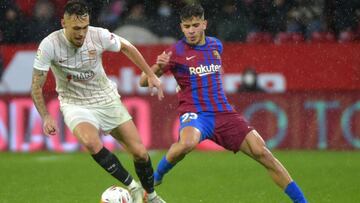 Sevilla's Argentinian midfielder Lucas Ocampos (L) is challenged by Barcelona's Moroccan forward Abde Ezzalzouli during the Spanish league football match between Sevilla FC and FC Barcelona at the Ramon Sanchez Pizjuan stadium in Seville on Dece