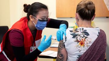 FILE PHOTO: Nurse Venus Lucero administers the first Pfizer-BioNTech COVID-19 vaccine at the Civic Hospital to Jo-Anne Miner at a vaccination clinic in Ottawa, Ontario, Canada December 15, 2020. Adrian Wyld/Pool via REUTERS/File Photo