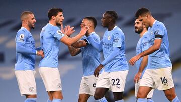 MANCHESTER, ENGLAND - NOVEMBER 28: Benjamin Mendy of Manchester City celebrates with teammate Ruben Dias after scoring his team's third goal during the Premier League match between Manchester City and Burnley at Etihad Stadium on November 28, 2020 i