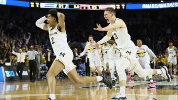 WICHITA, KS - MARCH 17: Jordan Poole #2 and Moritz Wagner #13 of the Michigan Wolverines celebrate Poole&#039;s 3-point buzzer beater for a 64-63 win over the Houston Cougars during the second round of the 2018 NCAA Men&#039;s Basketball Tournament at INTRUST Bank Arena on March 17, 2018 in Wichita, Kansas.   Jamie Squire/Getty Images/AFP
 == FOR NEWSPAPERS, INTERNET, TELCOS &amp; TELEVISION USE ONLY ==