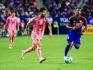 Jul 16, 2025; Cincinnati, Ohio, USA; Inter Miami CF forward Lionel Messi (10) dribbles against FC Cincinnati forward Sergio Santos (17) in the second half at TQL Stadium. Mandatory Credit: Katie Stratman-Imagn Images