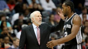 Oct 14, 2015; Atlanta, GA, USA; San Antonio Spurs head coach Gregg Popovich greets forward Kawhi Leonard (2) as he walk to the bench in the third quarter of their game against the Atlanta Hawks at Philips Arena. The Hawks won 100-86. Mandatory Credit: Jason Getz-USA TODAY Sports