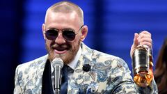 LAS VEGAS, NV - AUGUST 26: Conor McGregor speaks to the media while holding up his Notorious&#039; brand of whiskey after losing to Floyd Mayweather Jr. by 10th round TKO in their super welterweight boxing match on August 26, 2017 at T-Mobile Arena in Las Vegas, Nevada.   Ethan Miller/Getty Images/AFP
 == FOR NEWSPAPERS, INTERNET, TELCOS &amp; TELEVISION USE ONLY ==