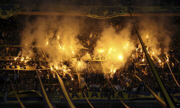 Boca Juniors' fans light flares during a local tournament soccer match against Union de Santa Fe in Buenos Aires, Argentina, Sunday