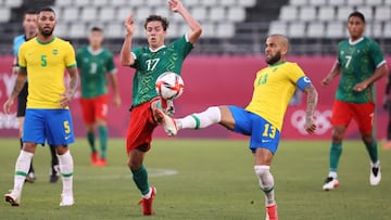 KASHIMA, JAPAN - AUGUST 03: Sebastian Cordova #17 of Team Mexico is challenged by Dani Alves #13 of Team Brazil during the Men&#039;s Football Semi-final match between Mexico and Brazil on day eleven of the Tokyo 2020 Olympic Games at Kashima Stadium on A