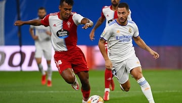 Celta Vigo's Peruvian midfielder Renato Tapia (L) challenges Real Madrid's Belgian forward Eden Hazard during the Spanish League football match between Real Madrid CF and RC Celta de Vigo at the Santiago Bernabeu stadium in Madrid on September 1