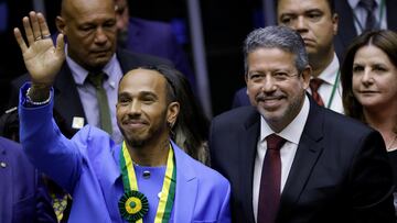 British Formula One racing driver, Lewis Hamilton gestures next to President of the Chamber Arthur Lira, after he received the title of honorary citizen of Brazil at the Chamber of Deputies in Brasilia, Brazil November 7, 2022. REUTERS/Adriano Machado