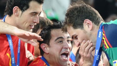 Spain's midfielder Xavi (C) squeezes captain and goalkeeper Iker Casillas' cheeks during the award ceremony following their 2010 FIFA football World Cup victory over the Netherlands.