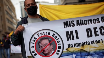 A demonstrator holds a sign that reads "No to the Petro reforms" during a protest against the government of Colombian President Gustavo Petro and his tax reform proposal in Bogota, Colombia October 22, 2022. REUTERS/Luisa Gonzalez