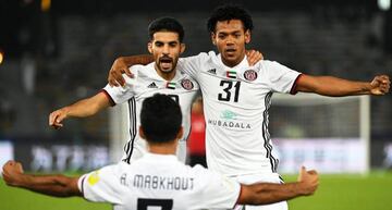 Ali Mabkhout (front) of Al Jazira celebrates with his teammates Mubarak Boussoufa (L) and Romarinho (R) after scoring the 1-0 lead during the FIFA Club World Cup quarter final match between Al Jazira Club and Urawa Red Diamonds in Abu Dhabi, UAE