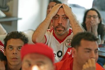 Fans of Argentina's River Plate team react after their team lost 2-1 the Copa Libertadores football final against Brazil's Flamengo at a bar in Buenos Aires, on November 23, 2019. 