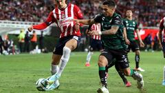 Victor Guzman (L) of Guadalajara vies for the ball with Carlos Orrantia (R) of Santos during their Mexican Clausura tournament football match at the Akron stadium in Guadalajara on March 4, 2023. (Photo by Ulises Ruiz / AFP)