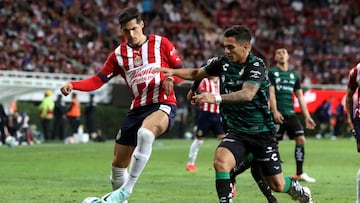 Victor Guzman (L) of Guadalajara vies for the ball with Carlos Orrantia (R) of Santos during their Mexican Clausura tournament football match at the Akron stadium in Guadalajara on March 4, 2023. (Photo by Ulises Ruiz / AFP)