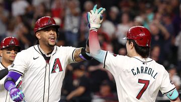 PHOENIX, ARIZONA - SEPTEMBER 29: (L-R) Ketel Marte #4 of the Arizona Diamondbacks high fives Corbin Carroll #7 after hitting a two-run home run during the fourth inning against the San Diego Padres at Chase Field on September 29, 2024 in Phoenix, Arizona. Chris Coduto/Getty Images/AFP (Photo by Chris Coduto / GETTY IMAGES NORTH AMERICA / Getty Images via AFP)