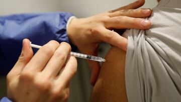 A medical worker administers a dose of the "Comirnaty" Pfizer-BioNTech COVID-19 vaccine in a vaccination center in Paris as part of the coronavirus disease (COVID-19) vaccination campaign in France, May 12, 2021. REUTERS/Gonzalo Fuentes