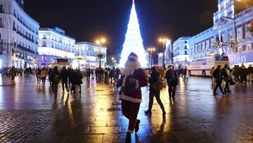 A street performer dressed as Santa Claus walks at Puerta del Sol as he waits for customers amid the coronavirus disease (COVID-19) pandemic in Madrid, Spain , December 14, 2020. REUTERS/Sergio Perez