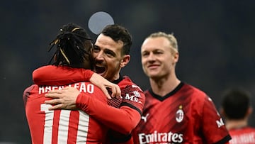 AC Milan's Portuguese forward #10 Rafael Leao celebrates with teammate AC Milan's Italian defender #42 Alessandro Florenzi after scoring the team's third goal during the UEFA Europa League Last 16 first leg between AC Milan and Rennes at the San Siro Stadium in Milan. (Photo by GABRIEL BOUYS / AFP)