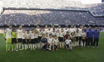 Los alevines del Valencia, campeones del torneo internacional de Arona y los jugadores del primer equipo posan antes del encuentro