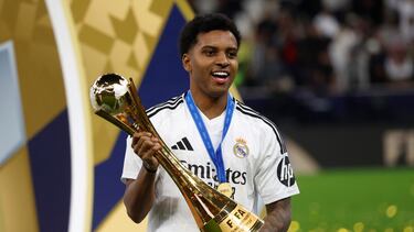 Real Madrid's Brazilian forward #11 Rodrygo poses with the tournament trophy during the podium ceremony after the 2024 FIFA Intercontinental Cup final football match between Spain's Real Madrid and Mexico's Pachuca at the Lusail Stadium in Doha on December 18, 2024. (Photo by KARIM JAAFAR / AFP)
