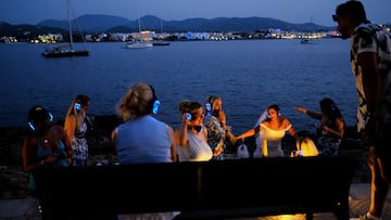 Tourists from Britain dance during sunset in the Sant Antoni de Portmany, on the north-central coast of Ibiza, Spain June 12, 2025. REUTERS/Nacho Doce