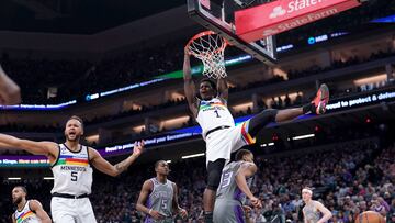 Minnesota Timberwolves guard Anthony Edwards (1) hangs on the rim after dunking the ball against the Sacramento Kings in the second quarter at the Golden 1 Center.