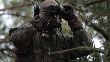 PABRADE, LITHUANIA - OCTOBER 27: An infantry soldier of the Bundeswehr, the German armed forces, looks through binoculars during the NATO Iron Wolf military exercises on October 27, 2022 in Pabrade, Lithuania. Germany leads a NATO contingent of troops in Lithuania under the Enhanced Forward Presence  (eFP) battle group, with troops also from Belgium, the Czech Republic, the Netherlands, Luxembourg and Norway.   (Photo by Sean Gallup/Getty Images)