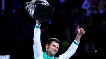 (FILES) This file photo taken on February 21, 2021 shows Serbia&#039;s Novak Djokovic celebrating with the Norman Brookes Challenge Cup trophy after beating Russia&#039;s Daniil Medvedev to win their men&#039;s singles final match on day fourteen of the Australian Open tennis tournament in Melbourne. - Tennis superstar Novak Djokovic&#039;s legal battle to stay in Australia and chase a record 21st Grand Slam opened on January 10, 2022, but public online access was delayed by a technical glitch, a court spokesman said. (Photo by David Gray / AFP) / -- IMAGE RESTRICTED TO EDITORIAL USE - STRICTLY NO COMMERCIAL USE --