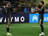 LOS ANGELES, CALIFORNIA - FEBRUARY 21: Denis Bouanga #99 of Los Angeles FC celebrates with teammate Timothy Tillman #11 after scoring the team's second goal during the MLS match between Los Angeles Football Club and Inter Miami CF at Los Angeles Memorial Coliseum on February 21, 2026 in Los Angeles, California. Kevork Djansezian/Getty Images/AFP (Photo by KEVORK DJANSEZIAN / GETTY IMAGES NORTH AMERICA / Getty Images via AFP)