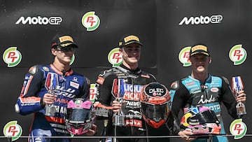 Winner Liqui Moly Dynavolt Intact GP team's Spanish rider Manuel Gonzalez (C), second-placed BLU CRU Pramac Yamaha Moto2 team's Spanish rider Izan Guevara (L) and third-placed CFMOTO Inde Aspar team's Spanish rider Daniel Holgado (R) celebrate on the podium after the Moto2 race at the MotoGP Thailand Grand Prix at the Buriram International Circuit in Buriram on March 1, 2026. (Photo by Lillian SUWANRUMPHA / AFP)