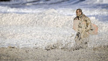 A rescue worker stands in rough waters during the resumed search for missing water sports participants in The North Sea at Scheveningen, The Netherlands on May 12, 2020. - The coastguard, police, fire brigade and KNRM are looking for potentially an additi