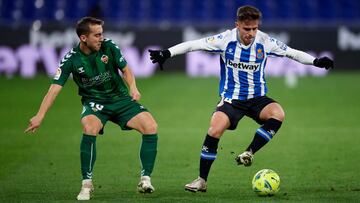 BARCELONA, SPAIN - JANUARY 10: Oscar Melendo of RCD Espanyol battles for possession with Ruben Diez of CD Castellon during the LaLiga SmartBank match between RCD Espanyol and CD Castellon at RCDE Stadium on January 10, 2021 in Barcelona, Spain. Sporting s