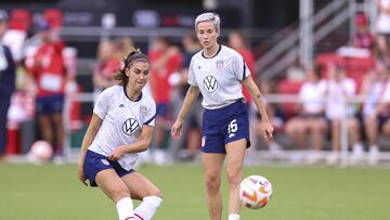 WASHINGTON, DC - SEPTEMBER 06: Alex Morgan #13 (L) and Megan Rapinoe #15 of the United States warm up before playing against Nigeria at Audi Field on September 06, 2022 in Washington, DC.   Tim Nwachukwu/Getty Images/AFP