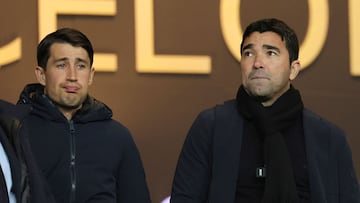 Former footballer Bojan Krkic (L) and Barcelona's Sports Director Anderson de Souza Deco wait for the start of the the Spanish league football match between FC Barcelona and CA Osasuna at the Estadi Olimpic Lluis Companys in Barcelona on January 31, 2024. (Photo by LLUIS GENE / AFP)