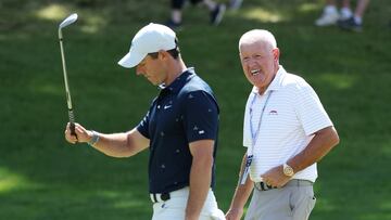 Rory McIlroy of Northern Ireland and his father, Gerry McIlroy, walk on the fourth hole during a practice round prior to the 2022 US Open.