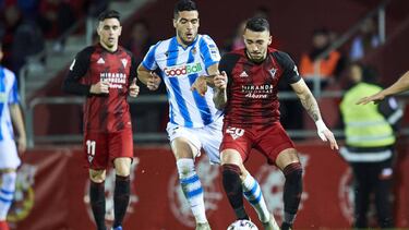 MIRANDA DE EBRO, SPAIN - MARCH 04: Mikel Merino of Real Sociedad duels for the ball with Antonio Sanchez of C.D Mirandes during the Copa del Rey semifinal 2nd leg match between Mirandes and Real Sociedad at Estadio Municipal de Anduva on March 04, 2020 in