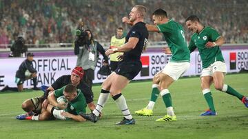 YOKOHAMA, JAPAN - SEPTEMBER 22: Ireland wing Andrew Conway scores the 4th Ireland try despite the attentions of Grant Gilchrist as Stuart Hogg (l) reacts during the Rugby World Cup 2019 Group A game between Ireland and Scotland at International Stadium Yo