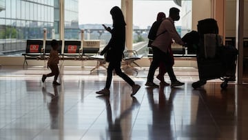 Passengers push a luggage trolley through the arrival lobby of Haneda Airport in Tokyo, Japan, on Tuesday, Oct. 11, 2022. Japan began accepting vaccinated visitors from 68 countries without visas Tuesday, ending almost three years of tighter border controls that kept tourists out of the island nation. Photographer: Toru Hanai/Bloomberg via Getty Images