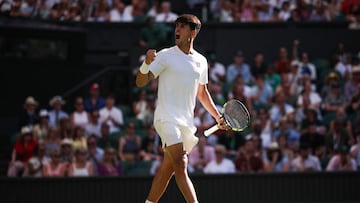 Spain's Carlos Alcaraz celebrates after winning a point against Italy's Fabio Fognini during their men's singles first round tennis match on the first day of the 2025 Wimbledon Championships at The All England Lawn Tennis and Croquet Club in Wimbledon, southwest London, on June 30, 2025. (Photo by HENRY NICHOLLS / AFP) / RESTRICTED TO EDITORIAL USE