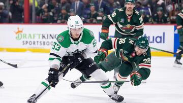 Dallas Stars center Wyatt Johnston (53) skates with the puck against the Minnesota Wild right wing Ryan Hartman (38) in the first period in game four of the first round of the 2023 Stanley Cup Playoffs at Xcel Energy Center. Mandatory Credit: Brad Rempel-USA TODAY Sports