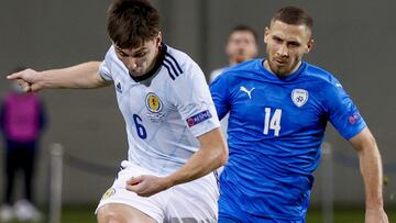 Scotland&#039;s defender Kieran Tierney (L) crosses the ball as he is closed down by Israel&#039;s forward Shon Weissman during the UEFA Nations League B Group 2 football match between Israel and Scotland at the Netanya Municipal Stadium in the Israeli ci