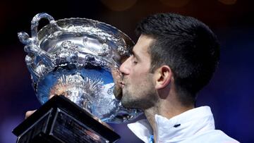 MELBOURNE, AUSTRALIA - JANUARY 29: Novak Djokovic of Serbia kisses the Norman Brookes Challenge Cup after winning the Men's Singles Final match against Stefanos Tsitsipas of Greece during day 14 of the 2023 Australian Open at Melbourne Park on January 29, 2023 in Melbourne, Australia. (Photo by Clive Brunskill/Getty Images)