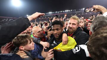 Soccer Football - Championship - AFC Bournemouth v Nottingham Forest - Vitality Stadium, Bournemouth, Britain - May 3, 2022 AFC Bournemouth's Jefferson Lerma celebrates promotion to the premier league with fans on the pitch after the match Action Images via Reuters/Matthew Childs EDITORIAL USE ONLY. No use with unauthorized audio, video, data, fixture lists, club/league logos or 'live' services. Online in-match use limited to 75 images, no video emulation. No use in betting, games or single club /league/player publications.  Please contact your account representative for further details.