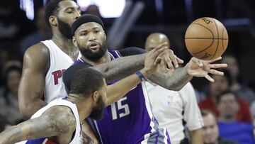 Sacramento Kings forward DeMarcus Cousins (15) passes the ball as Detroit Pistons center Andre Drummond, rear, and forward Marcus Morris close in during the second half of an NBA basketball game, Monday, Jan. 23, 2017, in Auburn Hills, Mich. (AP Photo/Carlos Osorio)