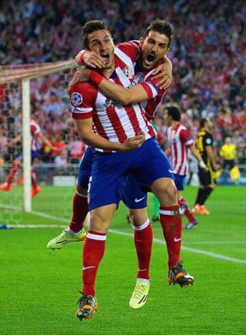 Koke celebrates with David Villa.