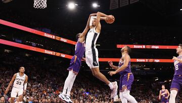 Victor Wembanyama #1 of the San Antonio Spurs slam dunks the ball against Keita Bates-Diop #21 of the Phoenix Suns during the first half of the NBA game at Footprint Center on November 02, 2023 in Phoenix, Arizona.