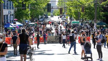 People walk around the newly created Capitol Hill Autonomous Zone (CHAZ), in Seattle, Washington on June 11, 2020. - The area surrounding the East Precinct building has come to be known as the CHAZ, Capitol Hill Autonomous Zone. Volunteer medics are avail