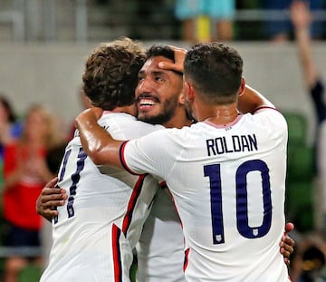 Jesés Ferreira (centre) is congratulated by Brenden Aaronson (left) and Christian Roldan after his fourth goal against Grenada.