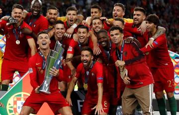 Portugal's players celebrate as Cristiano Ronaldo lifts the Nations League trophy.
